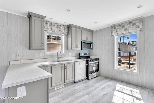 2505 Woodbridge Ave Unit 32Lane M, Edison, NJ 08817 - kitchen with wallpapered walls, gray cabinetry, a sink, and appliances with stainless steel finishes