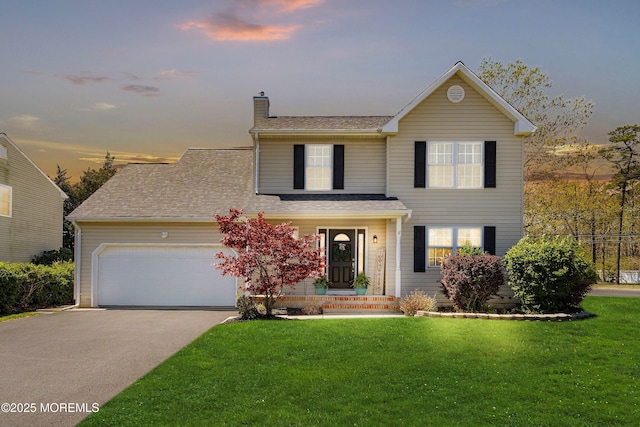 traditional home featuring a garage, a lawn, a chimney, and concrete driveway