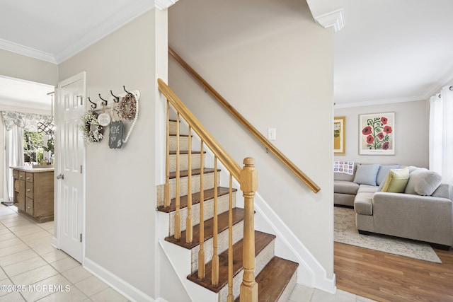 stairway with baseboards, ornamental molding, and tile patterned floors