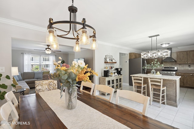 dining space featuring crown molding, ceiling fan with notable chandelier, and visible vents