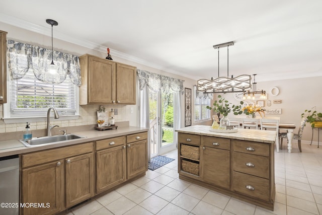 kitchen featuring a sink, ornamental molding, and a wealth of natural light