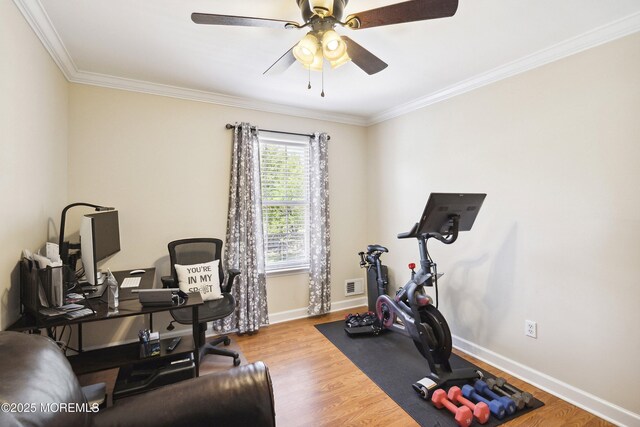 exercise room featuring crown molding, visible vents, wood finished floors, baseboards, and ceiling fan