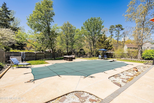 view of pool with a fenced in pool, a fenced backyard, and a patio area
