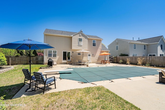 view of swimming pool with a lawn, a fenced in pool, a fenced backyard, a patio, and entry steps