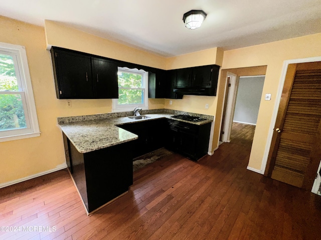 11 Green Hills Rd, East Brunswick, NJ 08816 - kitchen with a sink, black gas cooktop, baseboards, dark cabinets, and dark wood-style floors