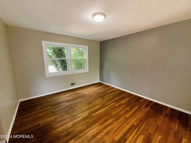 11 Green Hills Rd, East Brunswick, NJ 08816 - unfurnished room with dark wood finished floors and baseboards