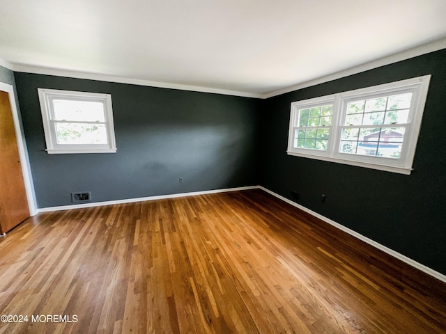 11 Green Hills Rd, East Brunswick, NJ 08816 - spare room featuring wood finished floors, a healthy amount of sunlight, crown molding, and visible vents