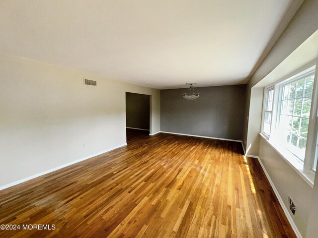 11 Green Hills Rd, East Brunswick, NJ 08816 - spare room featuring baseboards, wood finished floors, visible vents, and plenty of natural light