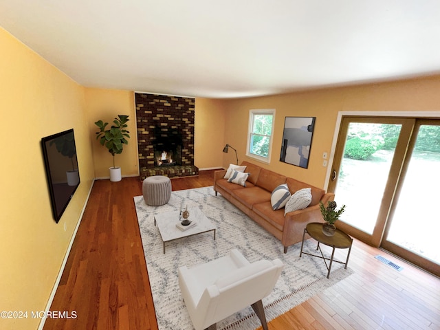 11 Green Hills Rd, East Brunswick, NJ 08816 - living area featuring wood finished floors, visible vents, and a brick fireplace