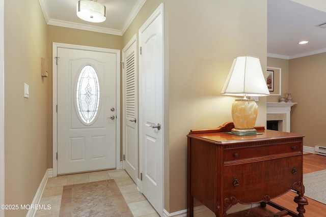 entryway with crown molding, a baseboard heating unit, baseboards, and recessed lighting
