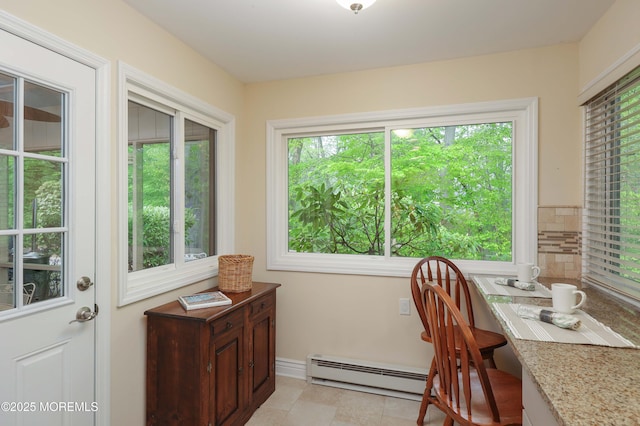 dining space with baseboards and a baseboard heating unit