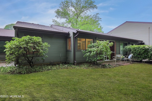 back of house featuring a yard and a patio area