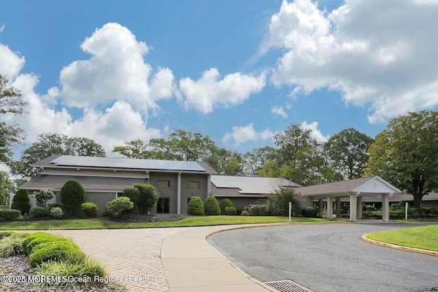 view of building exterior with curved driveway