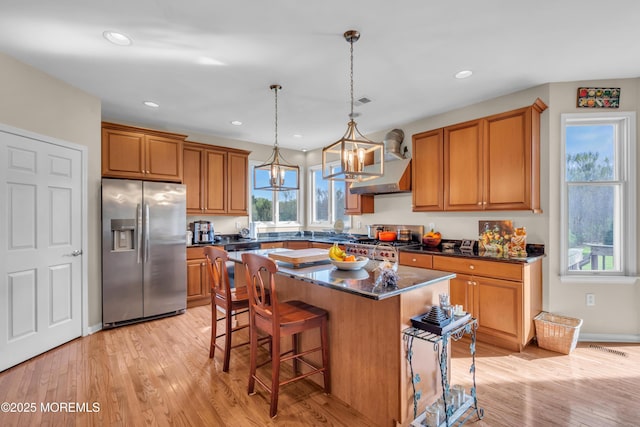 3 Scenic Way, Monroe, NJ 08831 - kitchen with a center island, brown cabinets, a breakfast bar, stainless steel fridge with ice dispenser, and range