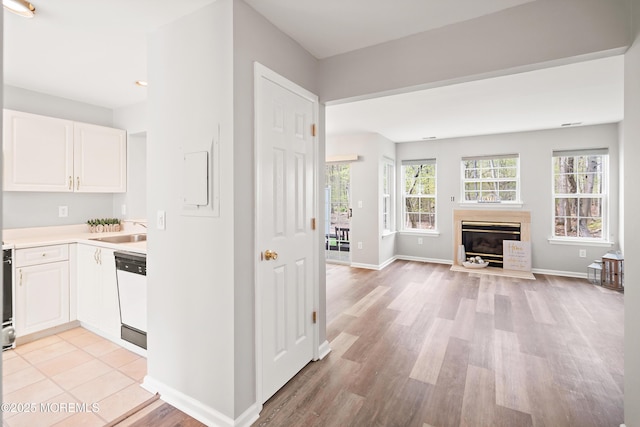 2304 Wendover Dr, Pompton Plains, NJ 07444 - interior space featuring white dishwasher, open floor plan, light wood-type flooring, light countertops, and white cabinets