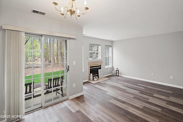 2304 Wendover Dr, Pompton Plains, NJ 07444 - interior space with wood finished floors, a glass covered fireplace, an inviting chandelier, baseboards, and visible vents
