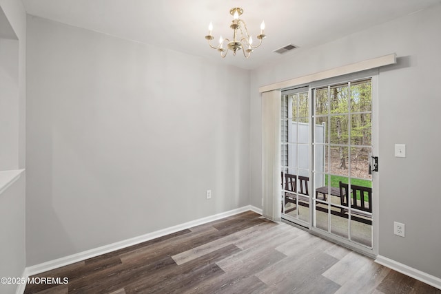 2304 Wendover Dr, Pompton Plains, NJ 07444 - unfurnished room with wood finished floors, visible vents, baseboards, and an inviting chandelier