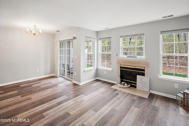 2304 Wendover Dr, Pompton Plains, NJ 07444 - unfurnished living room with a glass covered fireplace, wood finished floors, visible vents, and a healthy amount of sunlight