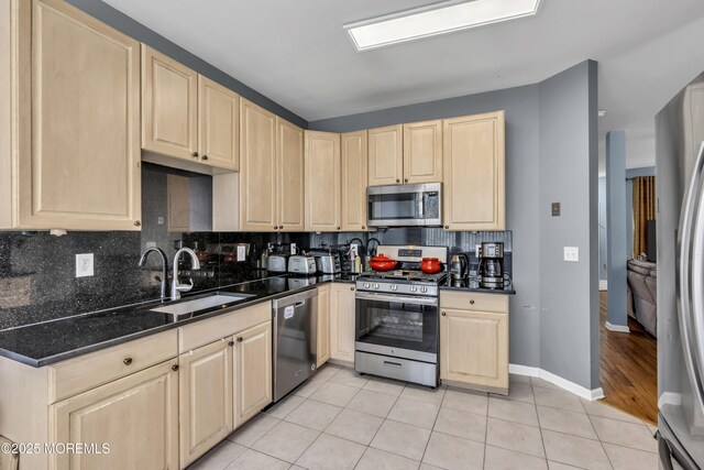 30 Frost Ln, East Windsor, NJ 08520 - kitchen with a sink, light tile patterned floors, light brown cabinetry, and stainless steel appliances
