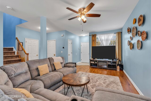 30 Frost Ln, East Windsor, NJ 08520 - living room featuring stairs, a ceiling fan, baseboards, and wood finished floors