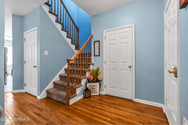 30 Frost Ln, East Windsor, NJ 08520 - entrance foyer with baseboards, visible vents, stairway, and hardwood / wood-style floors