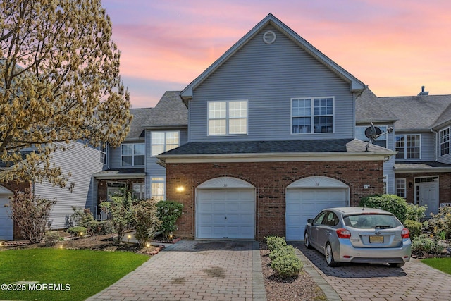 30 Frost Ln, East Windsor, NJ 08520 - view of front of home featuring brick siding, driveway, roof with shingles, and a garage