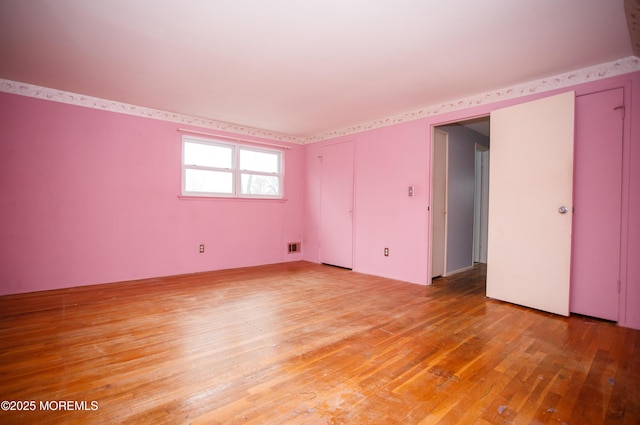 spare room with visible vents and light wood-type flooring