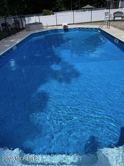 view of swimming pool with fence and a fenced in pool