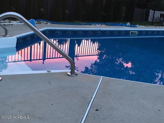 view of pool featuring fence