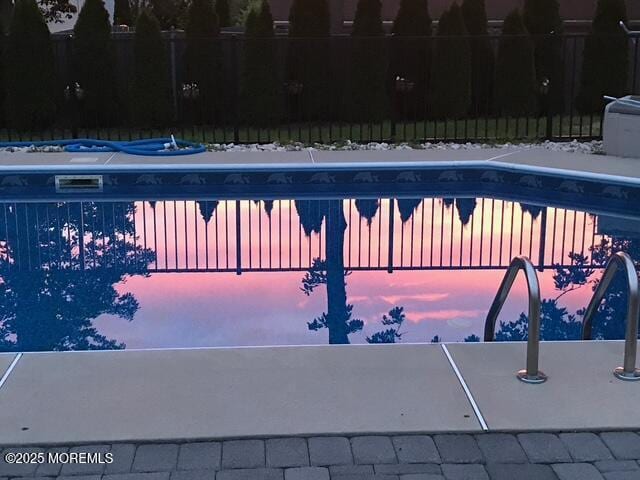 view of swimming pool with a fenced in pool