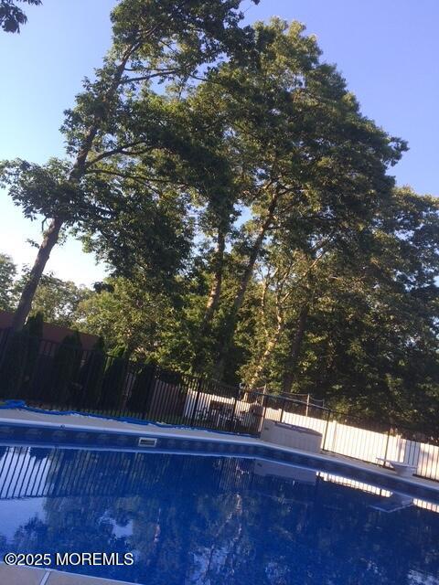 view of pool with a fenced in pool and fence