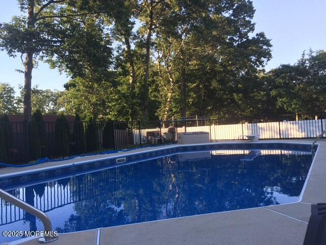 view of swimming pool with fence and a fenced in pool