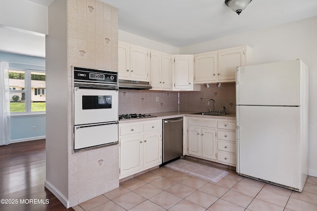 5 Pennsylvania Ave, Jackson, NJ 08527 - kitchen featuring stainless steel appliances, a warming drawer, backsplash, under cabinet range hood, and light countertops