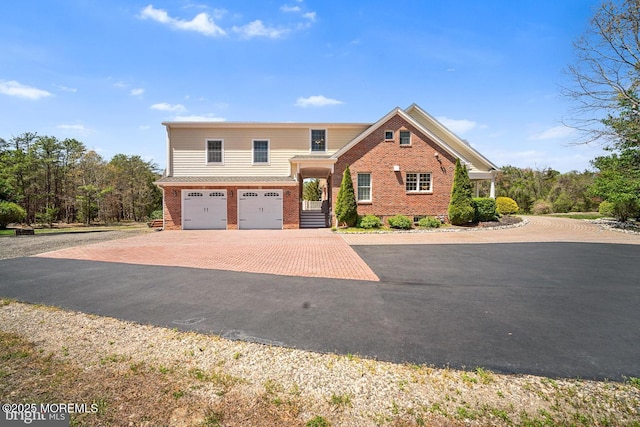 159 Sprague Ave, West Creek, NJ 08092 - view of front of property with brick siding, decorative driveway, and a garage