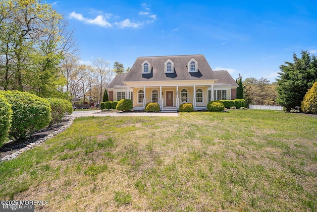 159 Sprague Ave, West Creek, NJ 08092 - new england style home featuring covered porch, fence, and a front lawn