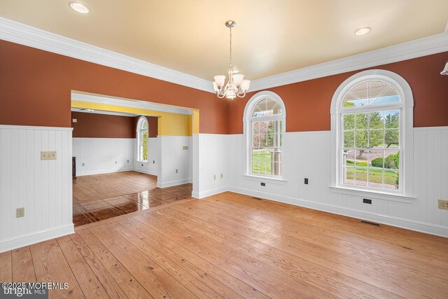 159 Sprague Ave, West Creek, NJ 08092 - empty room featuring an inviting chandelier, hardwood / wood-style floors, a wainscoted wall, a healthy amount of sunlight, and visible vents