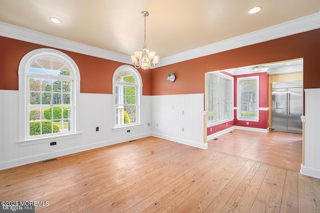 159 Sprague Ave, West Creek, NJ 08092 - empty room featuring visible vents, a chandelier, hardwood / wood-style flooring, and a wainscoted wall