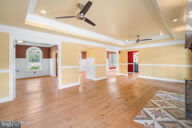 159 Sprague Ave, West Creek, NJ 08092 - unfurnished living room featuring light wood-style floors, a ceiling fan, a raised ceiling, and ornamental molding