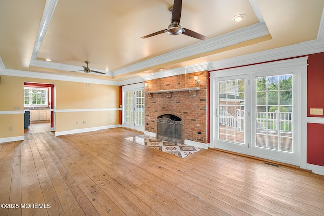 159 Sprague Ave, West Creek, NJ 08092 - unfurnished living room with crown molding, ceiling fan, a raised ceiling, a fireplace, and baseboards
