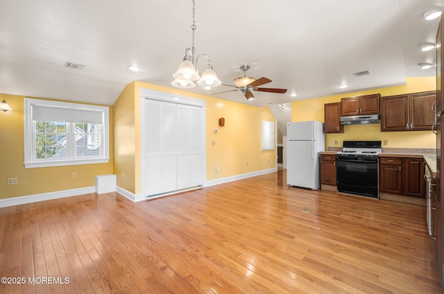 159 Sprague Ave, West Creek, NJ 08092 - kitchen with visible vents, freestanding refrigerator, gas range oven, under cabinet range hood, and light wood finished floors