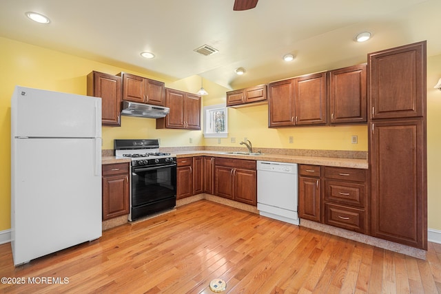 159 Sprague Ave, West Creek, NJ 08092 - kitchen featuring white appliances, under cabinet range hood, light wood-style flooring, and visible vents