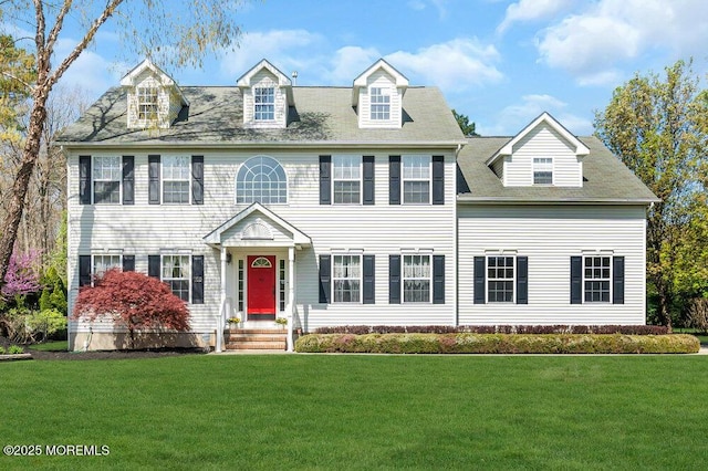 colonial inspired home with a front lawn