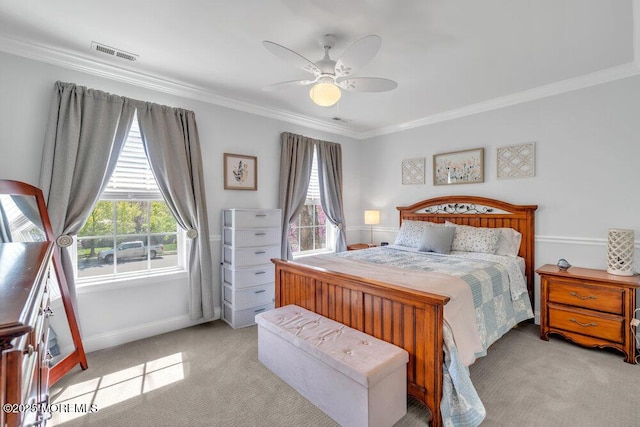 bedroom with crown molding, light colored carpet, and visible vents