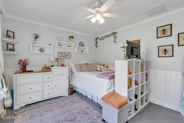 bedroom featuring crown molding, carpet flooring, wainscoting, and visible vents