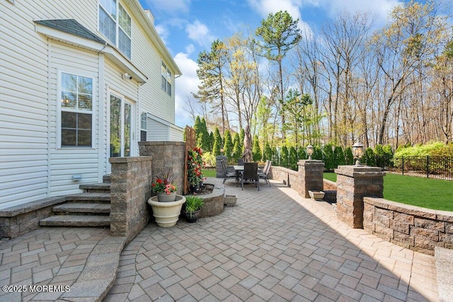 view of patio / terrace with outdoor dining area and fence