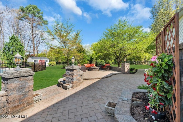 view of patio / terrace featuring fence and a fire pit