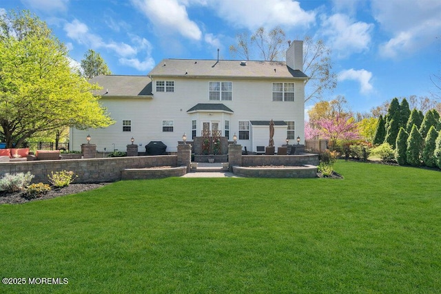 rear view of house featuring a lawn, fence, and a chimney