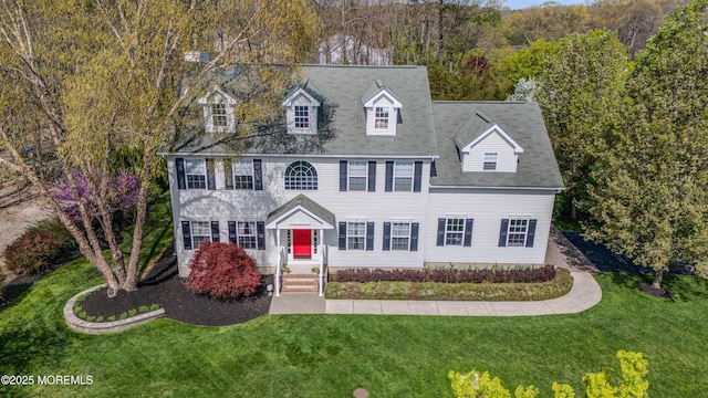 colonial inspired home with a front yard