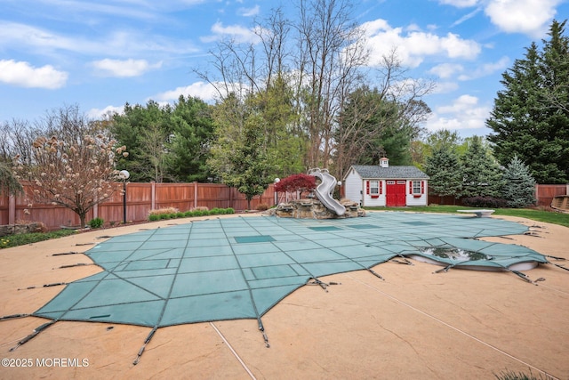 191 Robertsville Rd, Freehold, NJ 07728 - view of swimming pool featuring a fenced in pool, a water slide, a fenced backyard, and a patio
