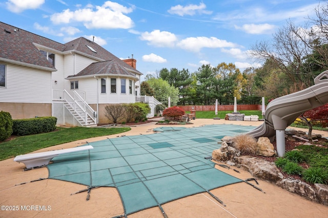 191 Robertsville Rd, Freehold, NJ 07728 - view of swimming pool with stairway, a patio area, fence, a water slide, and a covered pool